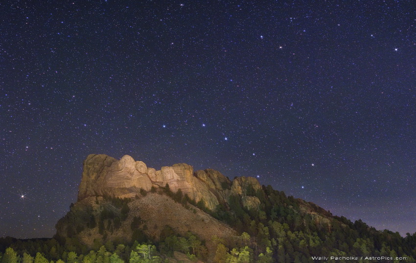 Über dem Mount Rushmore in South Dakota ragt der Große Wagen knapp über einen Berggipfel. Rechts oben ist der Kleine Wagen.