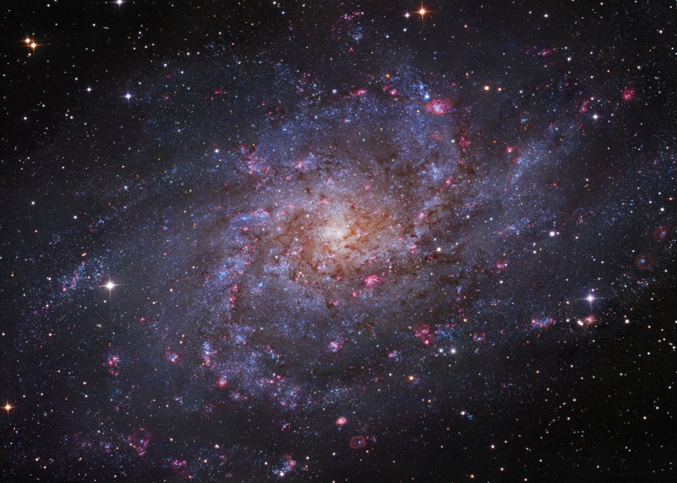 Bildfüllend ist eine zerfledderte Spiralgalaxie dargestellt. Es ist die Galaxie M33 im Sternbild Dreieck (Triangulum). Ihr Aussehen erinnert an ein Feuerrad.