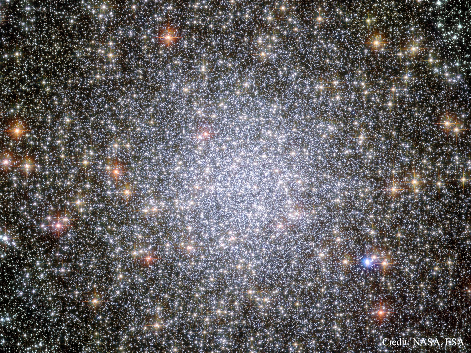 Mitten im Bild drängen sich unzählige Sterne zum Kugelsternhaufen 47 Tucanae im Sternbild Tukan. Kugelsternhaufen. Nach außen hin sind die Sterne weniger dicht verteilt, dazwischen leuchten mehr rötliche, helle Sterne.