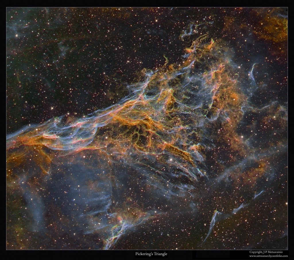 Die graublauen und orangefarbenen Nebelfetzen im Sternbild Schwan sind Teil des Schleiernebels. Sie sind als NGC 6979 katalogisiert, der Nebelteil heißt Williamina Flemings dreieckiges Büschel.